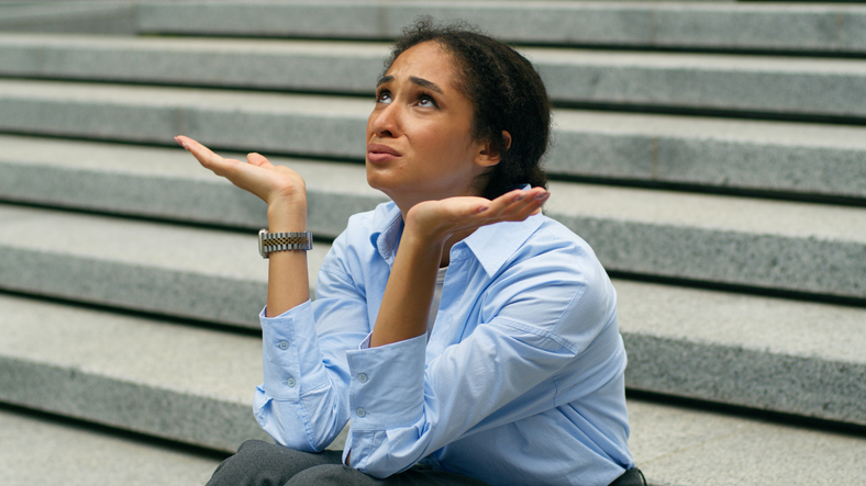 Depressed stressed African American businesswoman talking to God heaven upset business woman girl female employer suffering failure job lost in city sit on stairs headache unemployment crisis problem