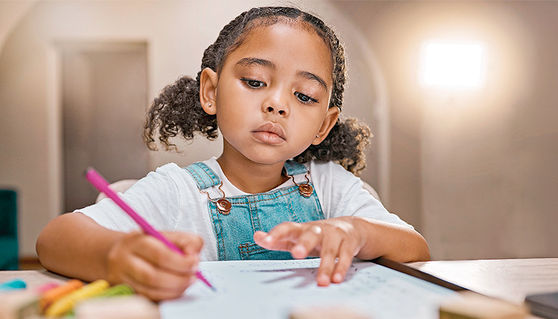 Girl, homework and writing on paper, learning and homeschool with math, education and knowledge at table in home. Latino child or student in brazil with concentration, school work and study in house
