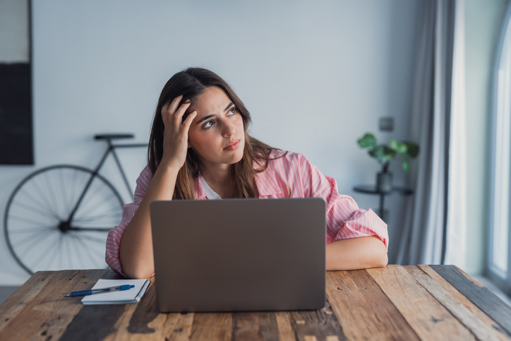 Frustrated stressed woman sit at desk near laptop hold head with