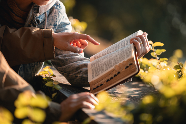 Reading the Bible and praying together outdoors